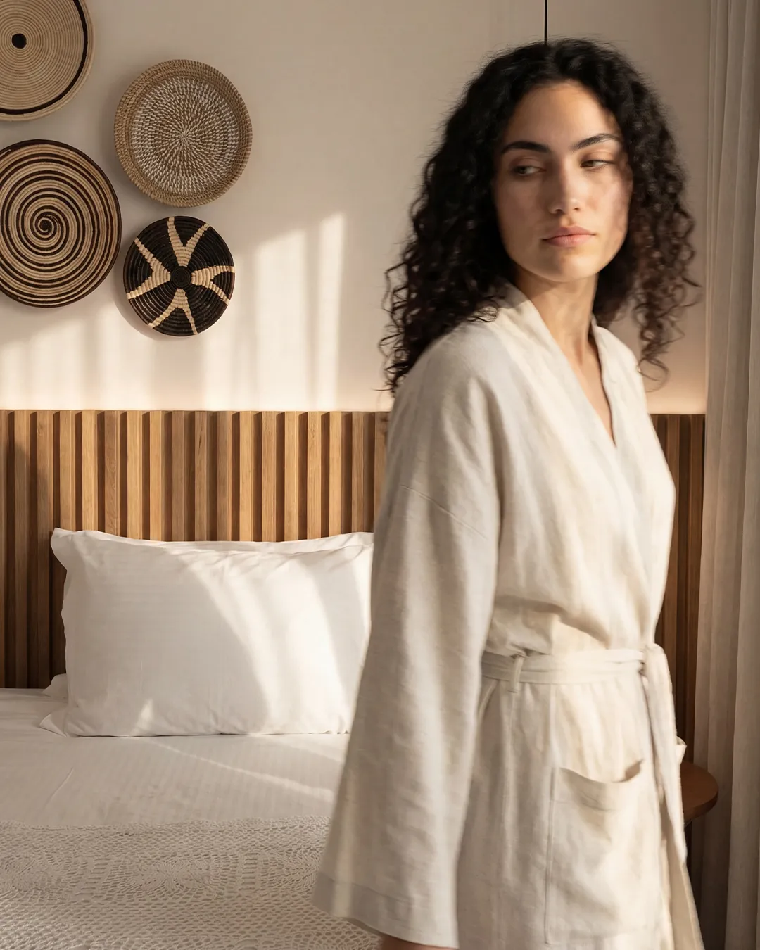 Guest in linen robe by hand-woven bedroom décor